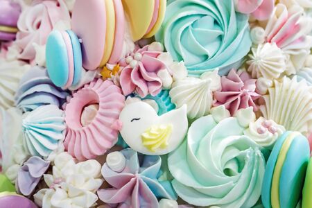 multicolored background of marshmallow sweets, macaroon cakes and cream. Pastel shades of colorの写真素材