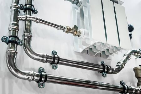 wiring of radiator pipes in the room on the wall. Example of pipe wiringの写真素材