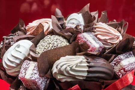 marshmallows, souffles, chocolate, candy and other sweets made up in a bouquetの写真素材