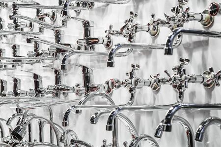 different types of water faucets and taps on the shop windowの写真素材
