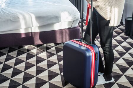 hotel visitor with a suitcase in the hotel room. Concept on the theme of arrival in the hotel roomの写真素材