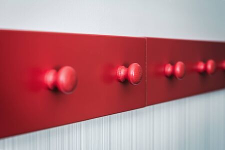 wooden red long hanger along the wall. Shallow depth of field