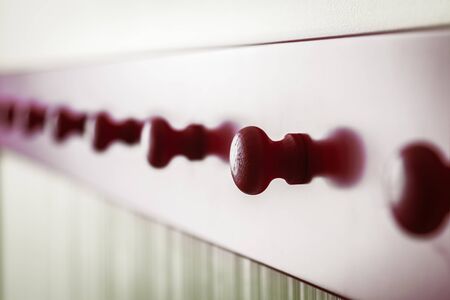 wooden red long hanger along the wall. Shallow depth of field, contour lightの写真素材