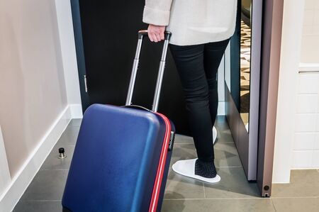 hotel visitor with a suitcase in the hotel room. Concept on the theme of arrival in the hotel roomの写真素材