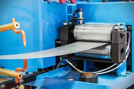 details of the machine for the production of pipes in a factory or production. Feed rolls of the machineの写真素材