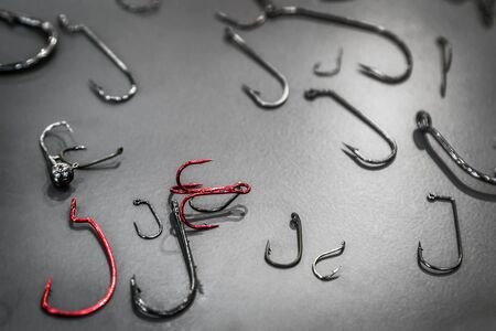 various fishing hooks on the table and offset and jig heads and tees for spinning and carpの写真素材