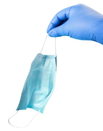 hand in a rubber protective glove holds a face mask isolated on a white backgroundの写真素材