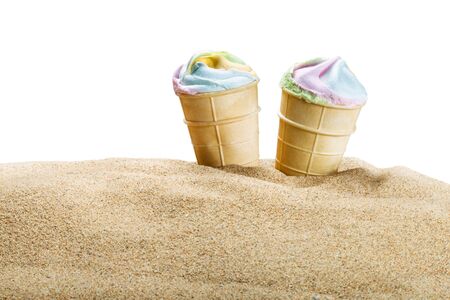 colorful ice cream in a waffle Cup on sand isolated on white backgroundの写真素材