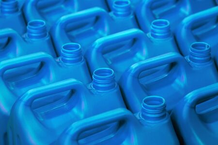 plastic canisters of light blue color in the warehouse, production, factory. Background from plastic canistersの写真素材