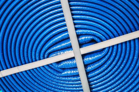 blue hose rolled up in a roll used for ventilation and air conditioning systemsの写真素材