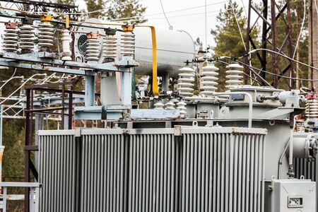 an old power plant with rusty wires, structures, and equipmentの写真素材