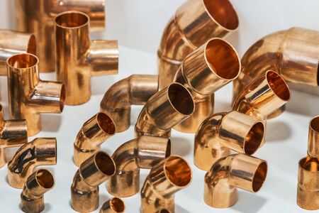 various parts and connections made of copper pipes for plumbing and climate engineering. Selective focusの写真素材