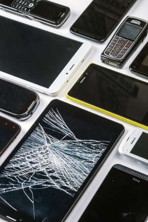 Moscow, Russia-may 19, 2020: outdated and modern models of smartphones and mobile phones. Background of dirty, broken and old smartphonesのeditorial素材