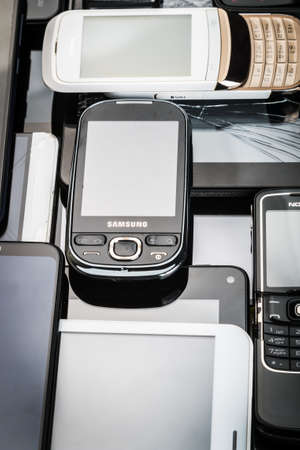 Moscow, Russia-may 19, 2020: outdated and modern models of smartphones and mobile phones. Background of dirty, broken and old smartphonesのeditorial素材