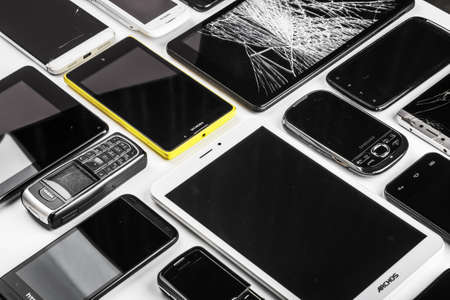 Moscow, Russia-may 19, 2020: outdated and modern models of smartphones and mobile phones. Background of dirty, broken and old smartphonesのeditorial素材