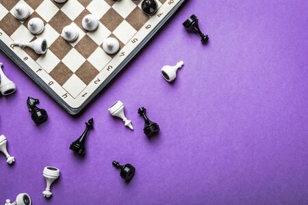 chess figures and a chessboard in the game played on a lilac backgroundの写真素材