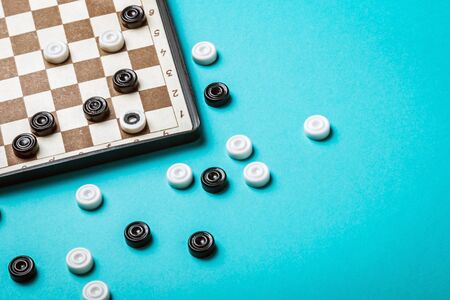 game of checkers played on a blue backgroundの写真素材
