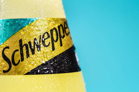 Moscow, Russia-June 16, 2020: Schweppes carbonated drink in a plastic bottle on a blue background. Schweppes is a brand of soft drinks founded by Jacob Schwepp in 1783のeditorial素材