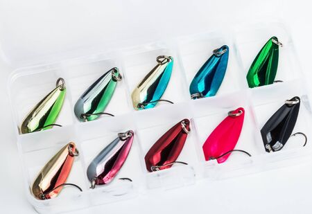 small fishing lure for catching predatory fish in a box on a light backgroundの写真素材