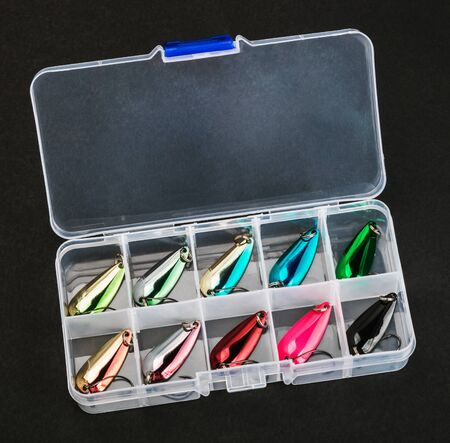 small fishing lure for catching predatory fish in a box on a black backgroundの写真素材
