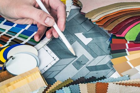 select a colour from the color sample pellets in the designer's workspace. choice of materials, textures and colors for room renovation and decorationの写真素材