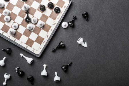 chessboard and chess pieces in a played game on a black background. Magnetic road chess gameの写真素材