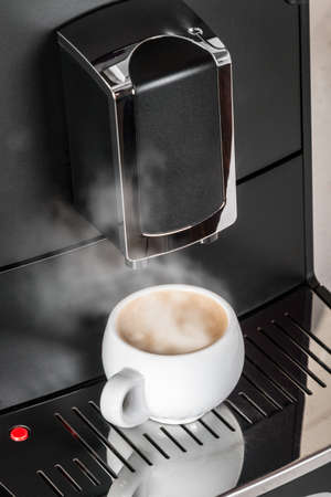 ceramic Cup of coffee Prepared on the coffee machineの写真素材