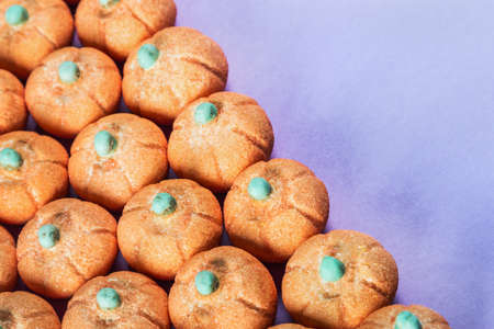 small marshmallow pumpkins with a sprinkle of sugar on a lilac background. Concept for the Halloween holidayの写真素材