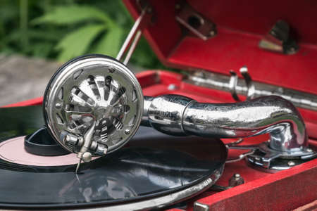 playing an old retro gramophone with an old vinyl recordの写真素材