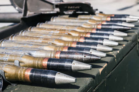 training large-caliber cartridges from the gun in the tape are on wooden boxesの写真素材