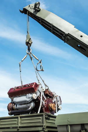 the crane boom raises or lowers the engine for replacement or repairの写真素材