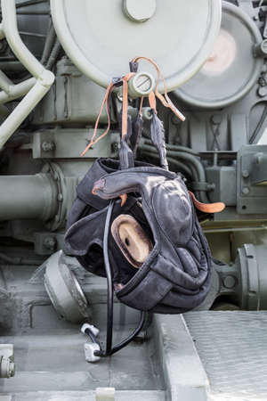 protective military helmet of the tank crew lie on the tanks armorの写真素材