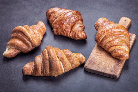 croissants lie on the black breakfast tableの写真素材