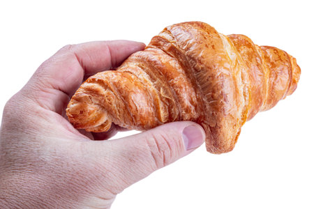 croissant in hand isolated on white backgroundの写真素材