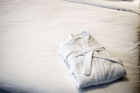 the bathrobes are folded on the bed in the hotel roomの写真素材