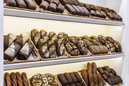 many different types of bread. Wholegrain, round, rolls and loaves, with seedsの写真素材
