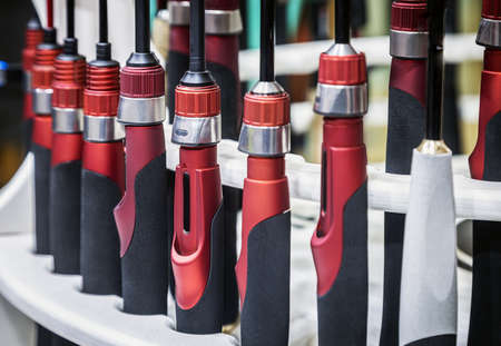 fishing rods of different construction and purpose on the counter of the storeの写真素材