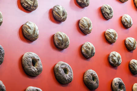 loaves of bread hang on the red wallの写真素材