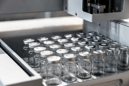 empty test tube and glass vials are placed in the counter of a medical centerの写真素材