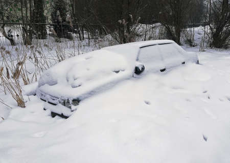 cars abandoned and covered with snowの写真素材
