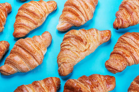 freshly baked croissants lie on a blue backgroundの写真素材