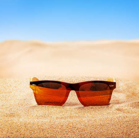 sunglasses on the sand in the desertの写真素材