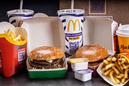 various burgers with French fries, cola and sauces from McDonalds restaurantのeditorial素材