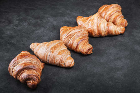 croissants lie on the black breakfast tableの写真素材