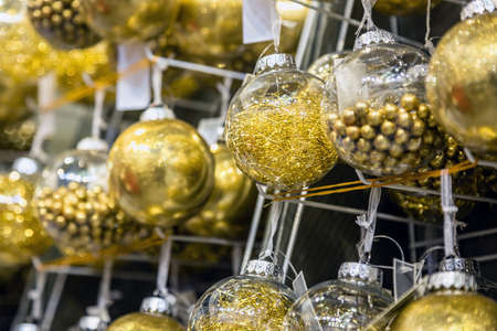 Christmas ball hangs on a shelf in the store among other Christmas toysの写真素材
