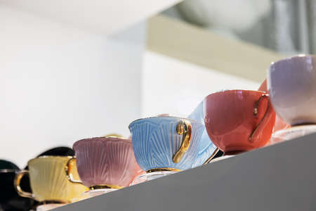 different-colored porcelain cups are on the counterの写真素材