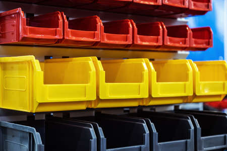 plastic boxes of different colors used in warehousesの写真素材