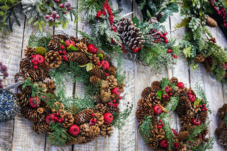 beautiful Christmas wreaths on the door and decorations of different colorsの写真素材