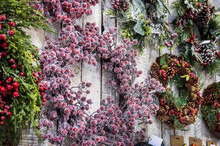 beautiful Christmas wreaths on the door and decorations of different colorsの写真素材