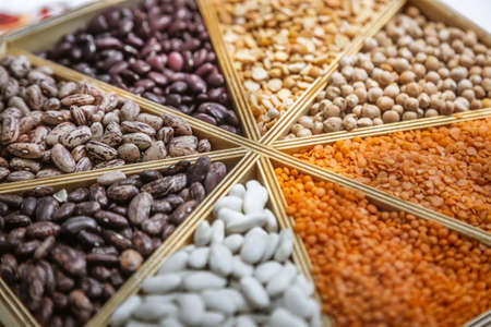 different varieties of beans and lentils in a wooden boxの写真素材